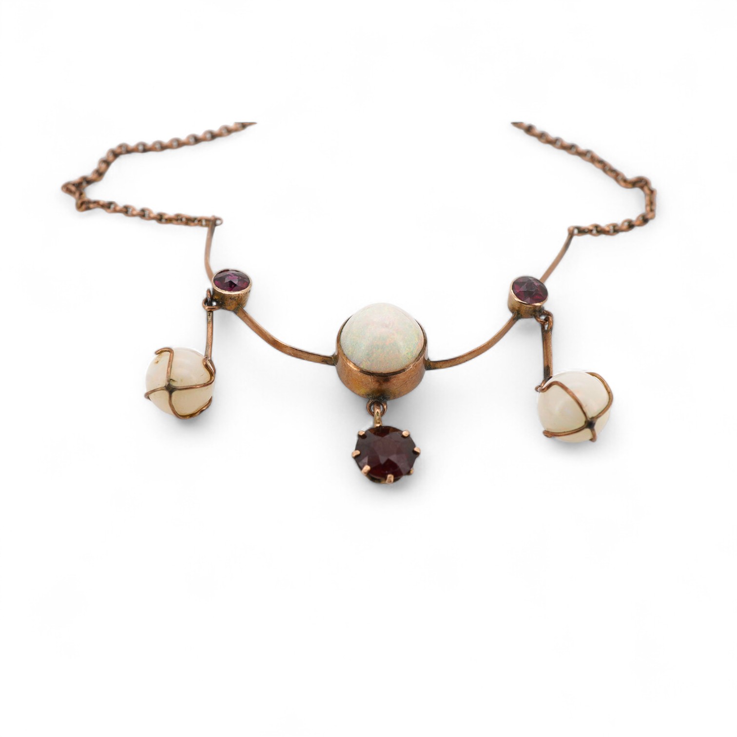 An early 20th century yellow metal, thee stone white opal and three stone garnet set drop necklace, approximately 44cm.